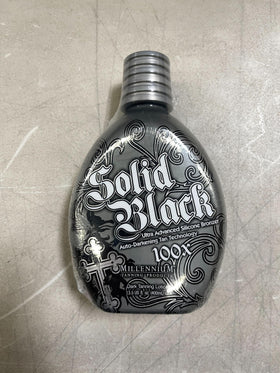 Millennium Tanning bottle next to a hand for size comparison and 13.5 fl oz scale