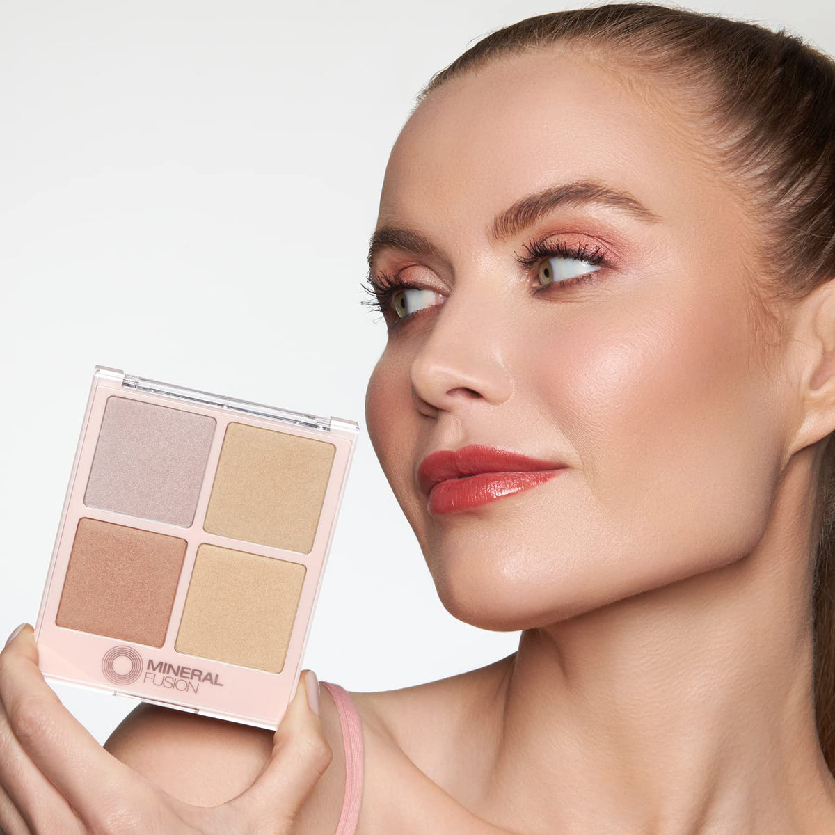 Mineral Fusion held in hand to show compact size and travel-friendly portability benefit