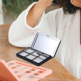 minkissy held in hand using mirror for quick on-the-go touch-ups