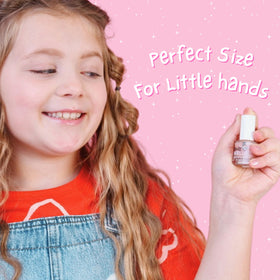 MISS NELLA bottle beside coin for scale illustrating compact size for small hands