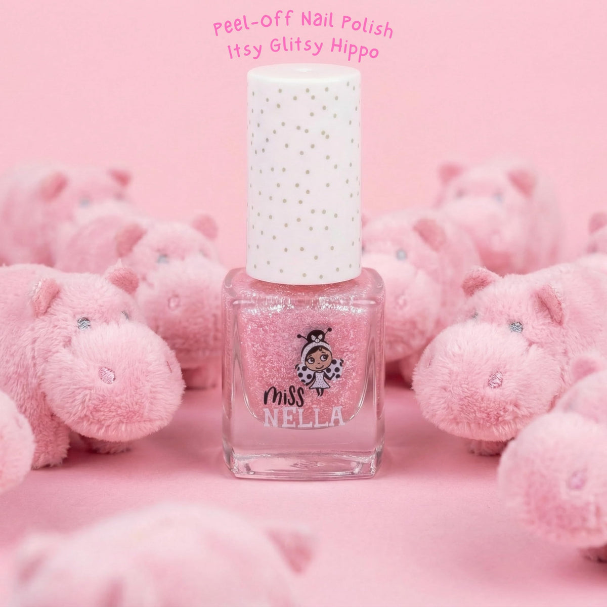 MISS NELLA bottle beside a child hand to show compact size and portability