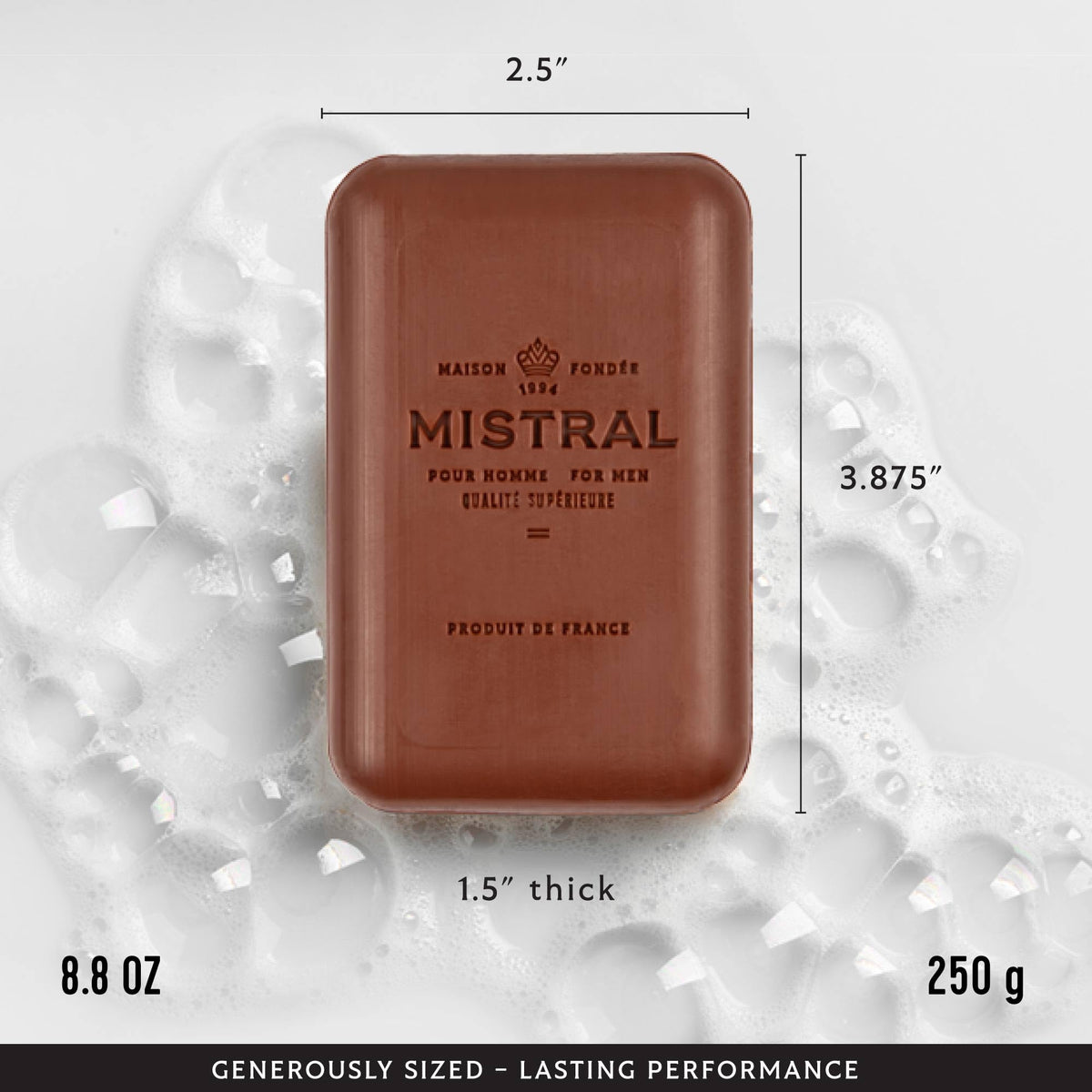 Mistral Mahogany Rum bar held in hand to show size and scale, demonstrates generous 8.8 oz weight
