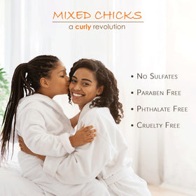 Applying Mixed Chicks conditioner to a child's hair for gentler detangling and comfort
