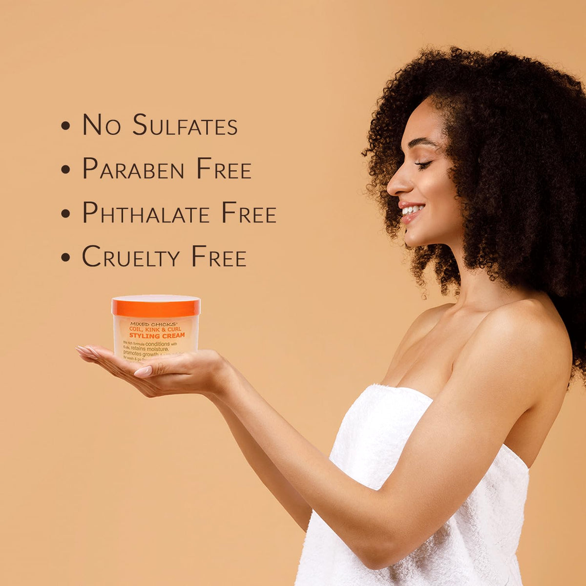 Applying Mixed Chicks cream in hands to show easy spread and styling benefit