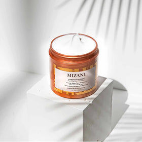 Mizani in-use on curly hair overnight demonstrating strengthened, smoother strands