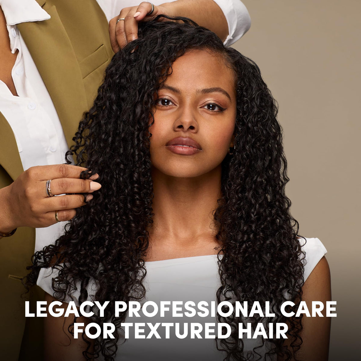 Mizani product in curly hair lifestyle setting, highlights soft defined curls