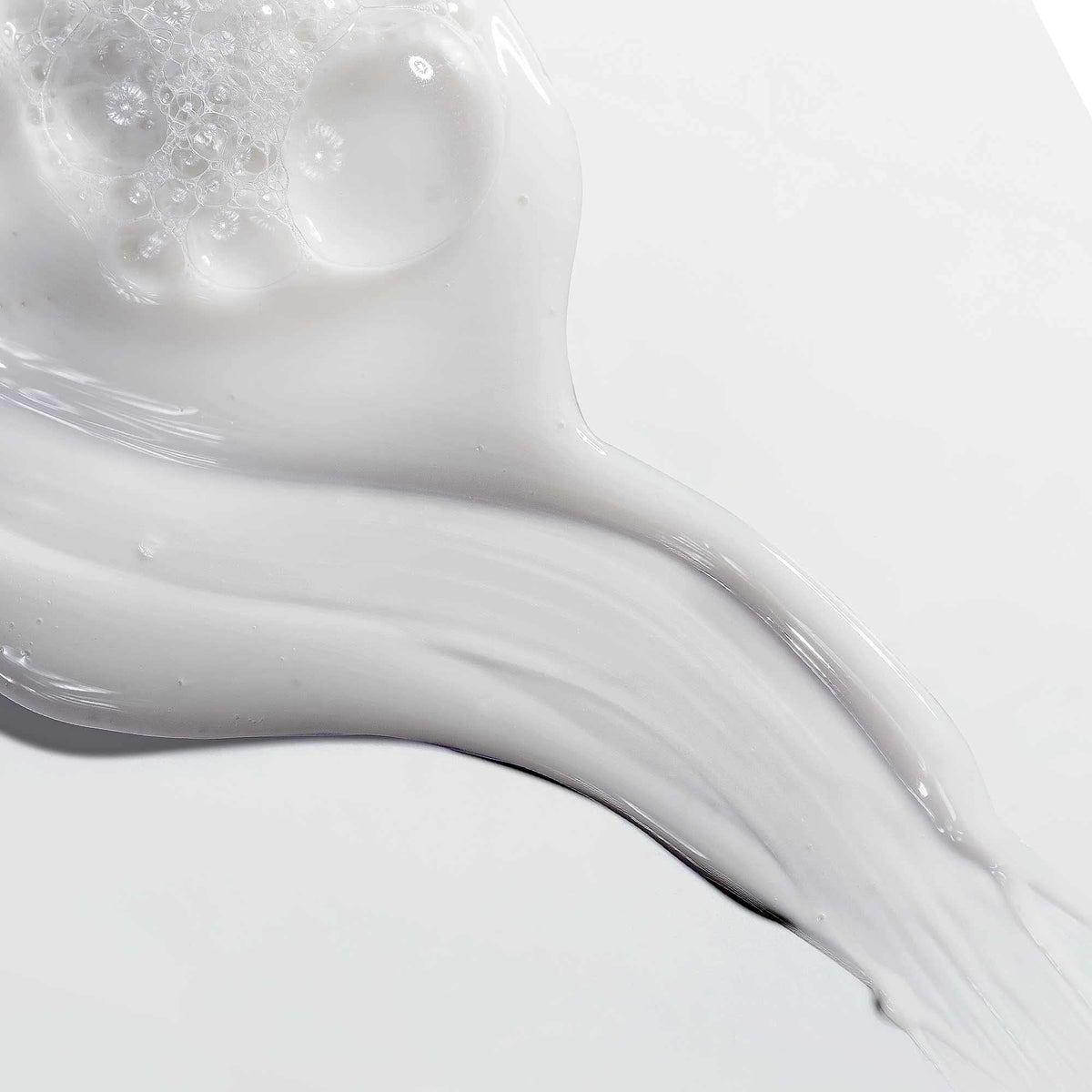 Mizani in-shower use showing shampoo rinsing for clean hair prep