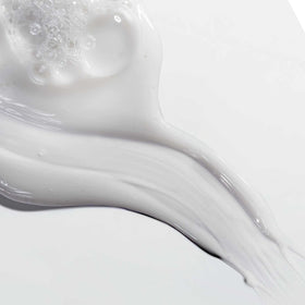 Mizani in-shower use showing shampoo rinsing for clean hair prep