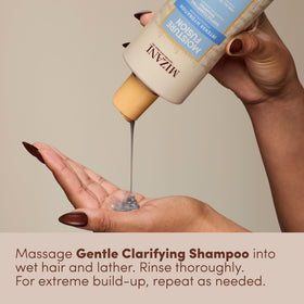 Mizani product beside hand for scale illustrating bottle size and travel readiness