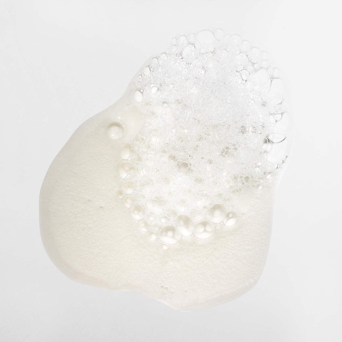Mizani suds on curly hair during wash, demonstrates gentle lathering