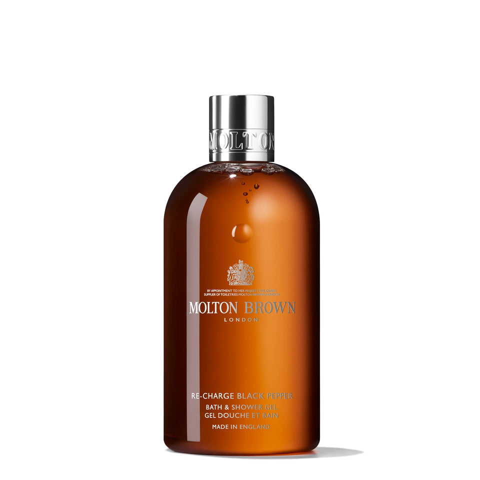 Molton Brown bottle front packaging shows branding and spicy woody scent benefit