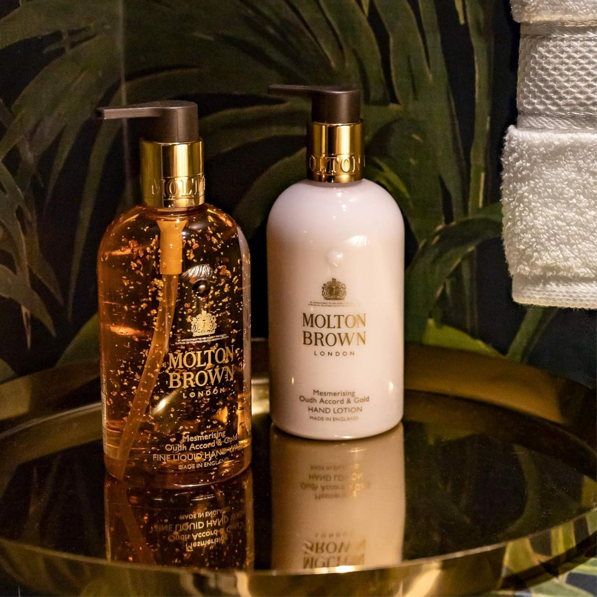 Molton Brown bottle staged with oudh and resin props conveying rich scent benefit