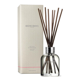 Molton Brown front bottle showing rhubarb and rose scent, brightens rooms