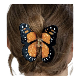 Generic Monarch butterfly clip worn in styled bun, holds hair securely while enhancing appearance
