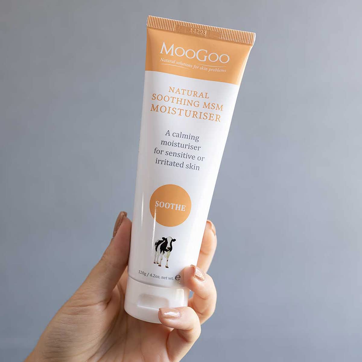 MooGoo cream being dispensed to hand demonstrating easy absorption benefit