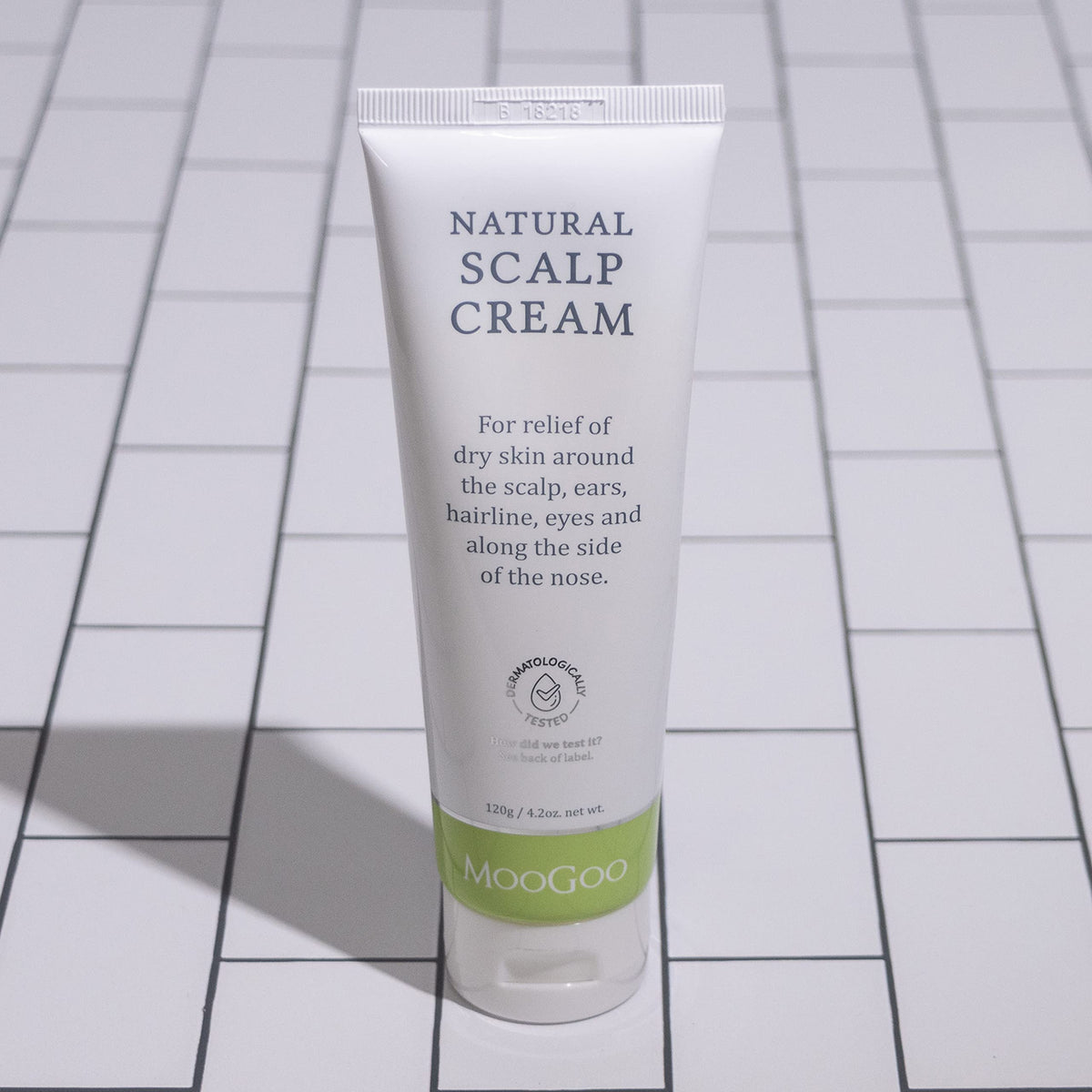 MooGoo next to ruler showing 120g size for scale and travel-friendly benefit