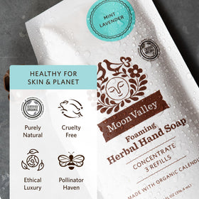 Moon Valley Organics pouch next to a foaming bottle for size and refill comparison