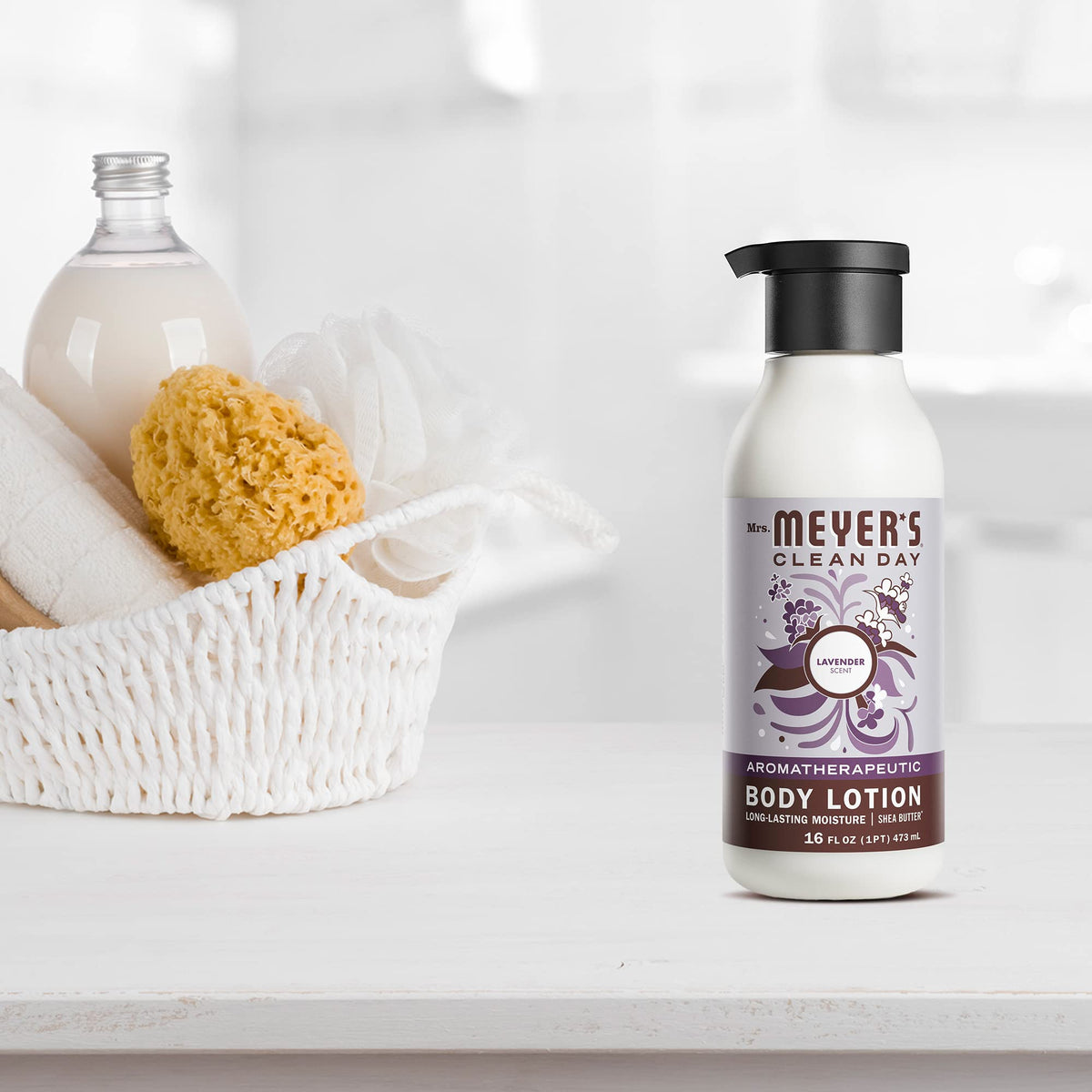 Mrs. MEYER'S bottle next to hand showing 16 fl oz scale and travel-friendly size