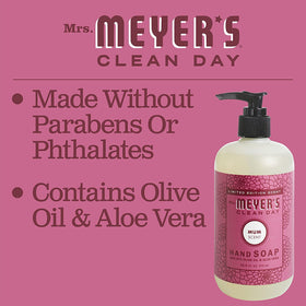 Mrs. MEYER'S bottle next to a hand for size comparison and countertop fit
