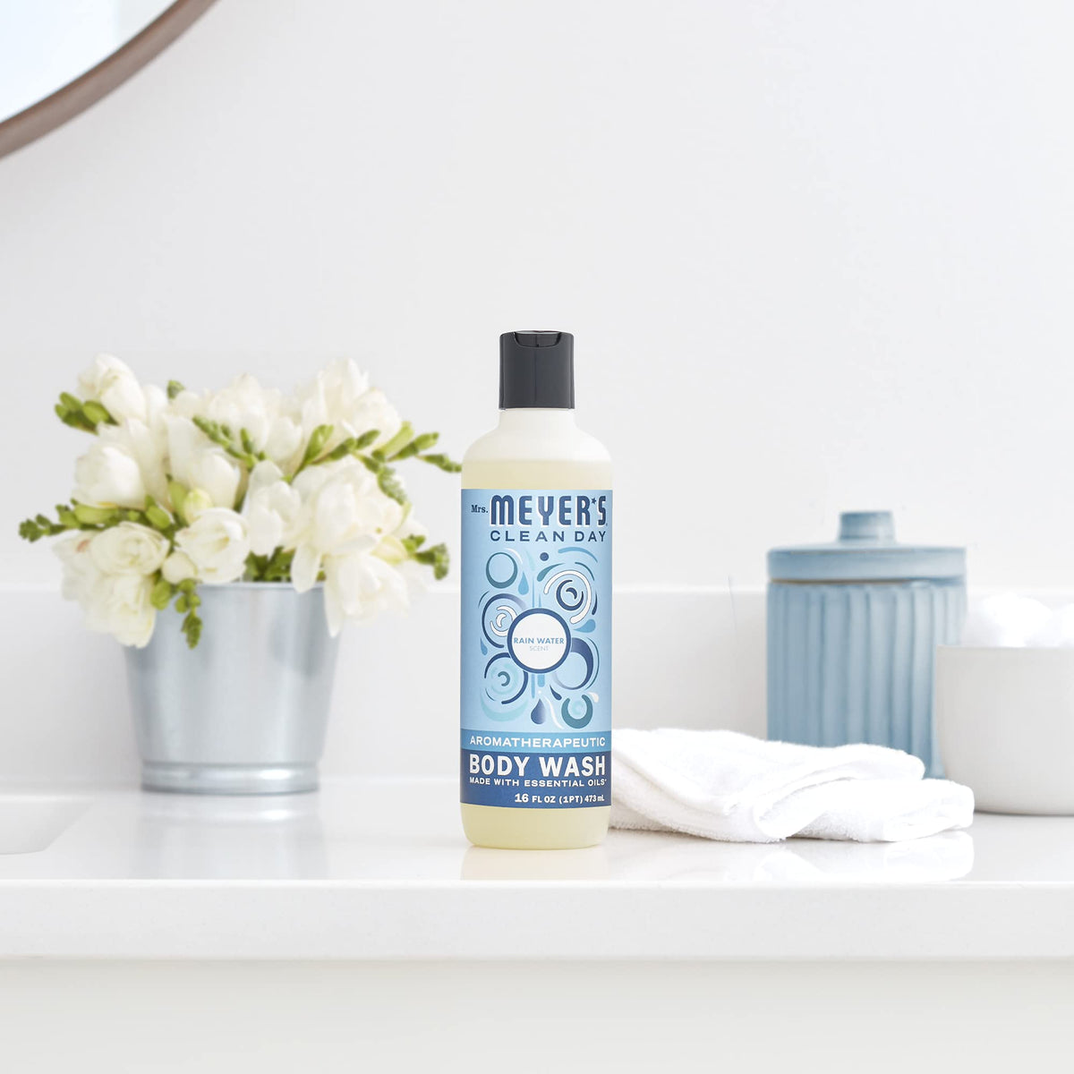 Mrs. Meyer's Rain Water bottle on bathroom shelf showcasing cohesive home fragrance