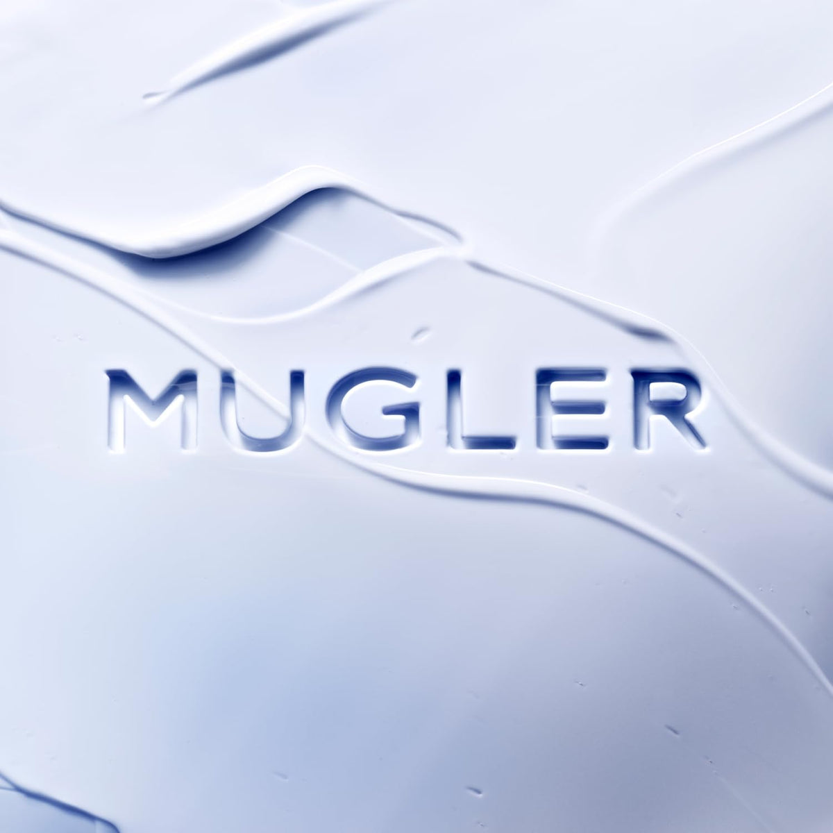 Mugler Angel lotion texture pouring from tube showing creamy hydration benefit