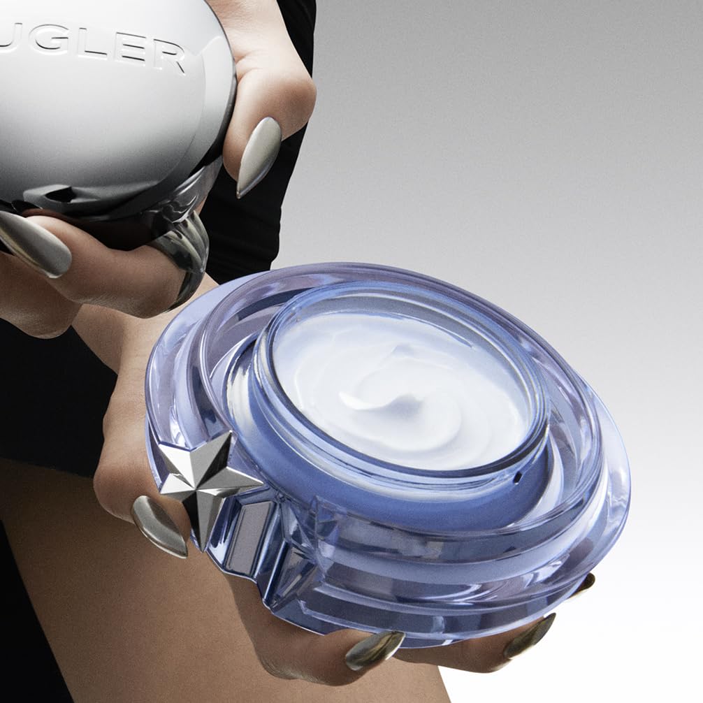 Mugler angel on vanity lifestyle shot with perfume bottle suggesting layered scent benefit