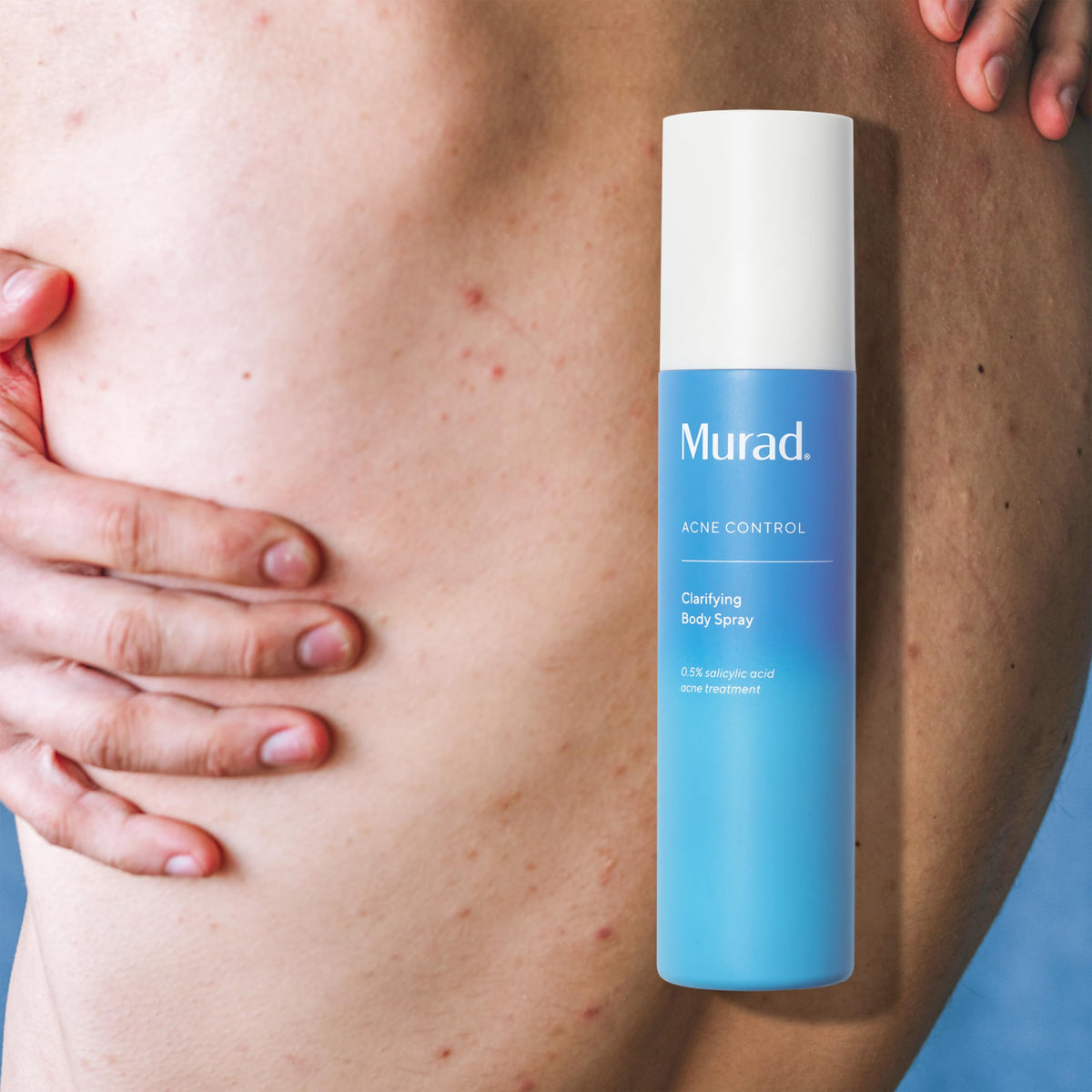 Murad bottle held in hand for scale demonstrating convenient size