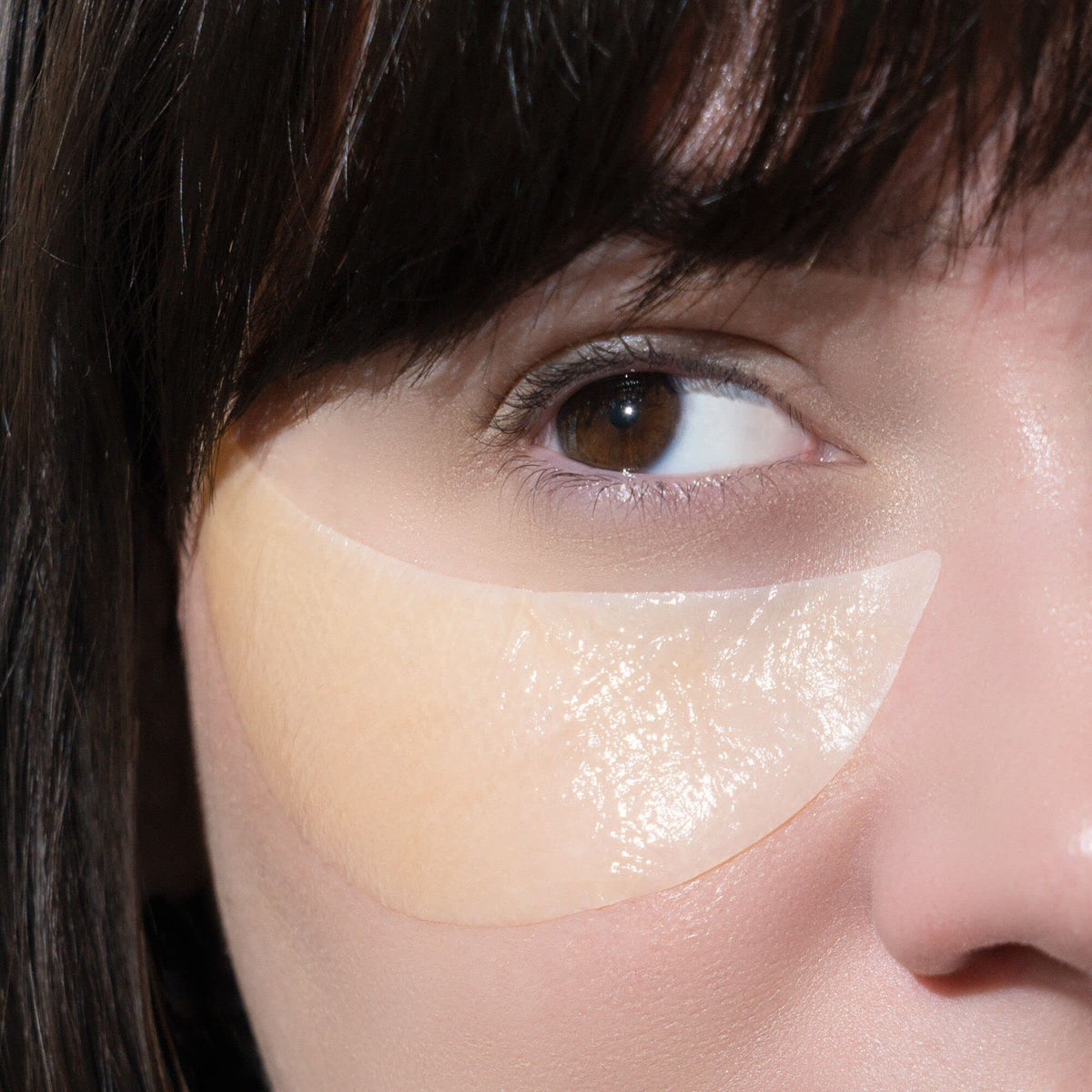 Murad eye masks held in hand showing extra-large coverage and scale