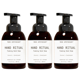 Muse Apothecary front bottle showing Coconut + Sandalwood branding and elegant label benefit
