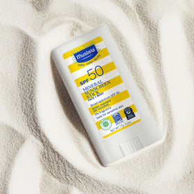 Mustela stick with beach bag lifestyle showing water-resistant convenience
