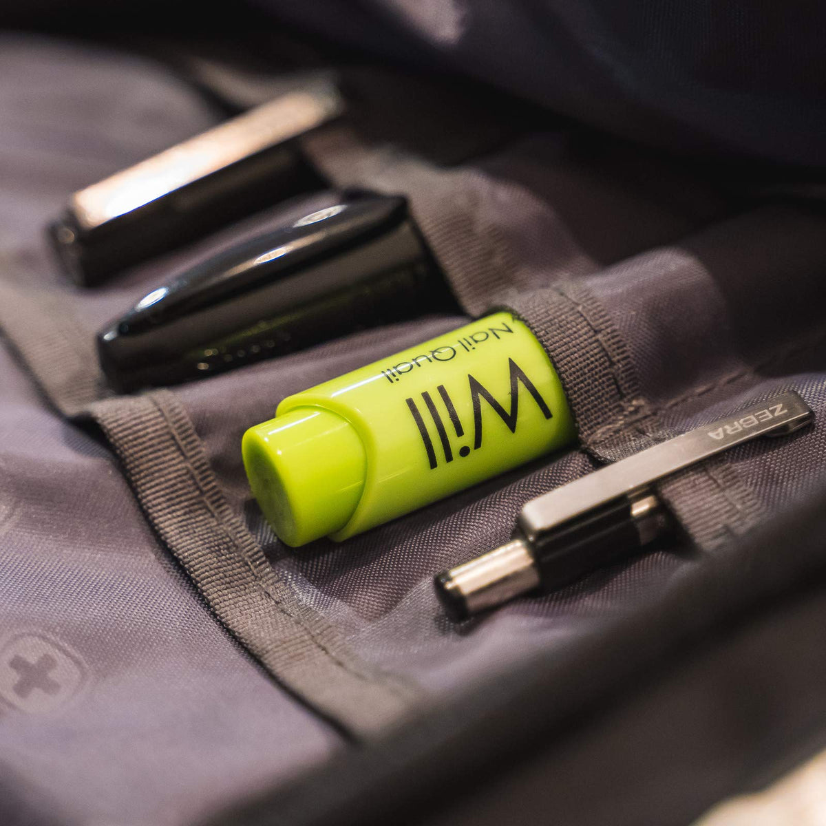 Nail Quail pen held in hand to show 7ml size and travel convenience