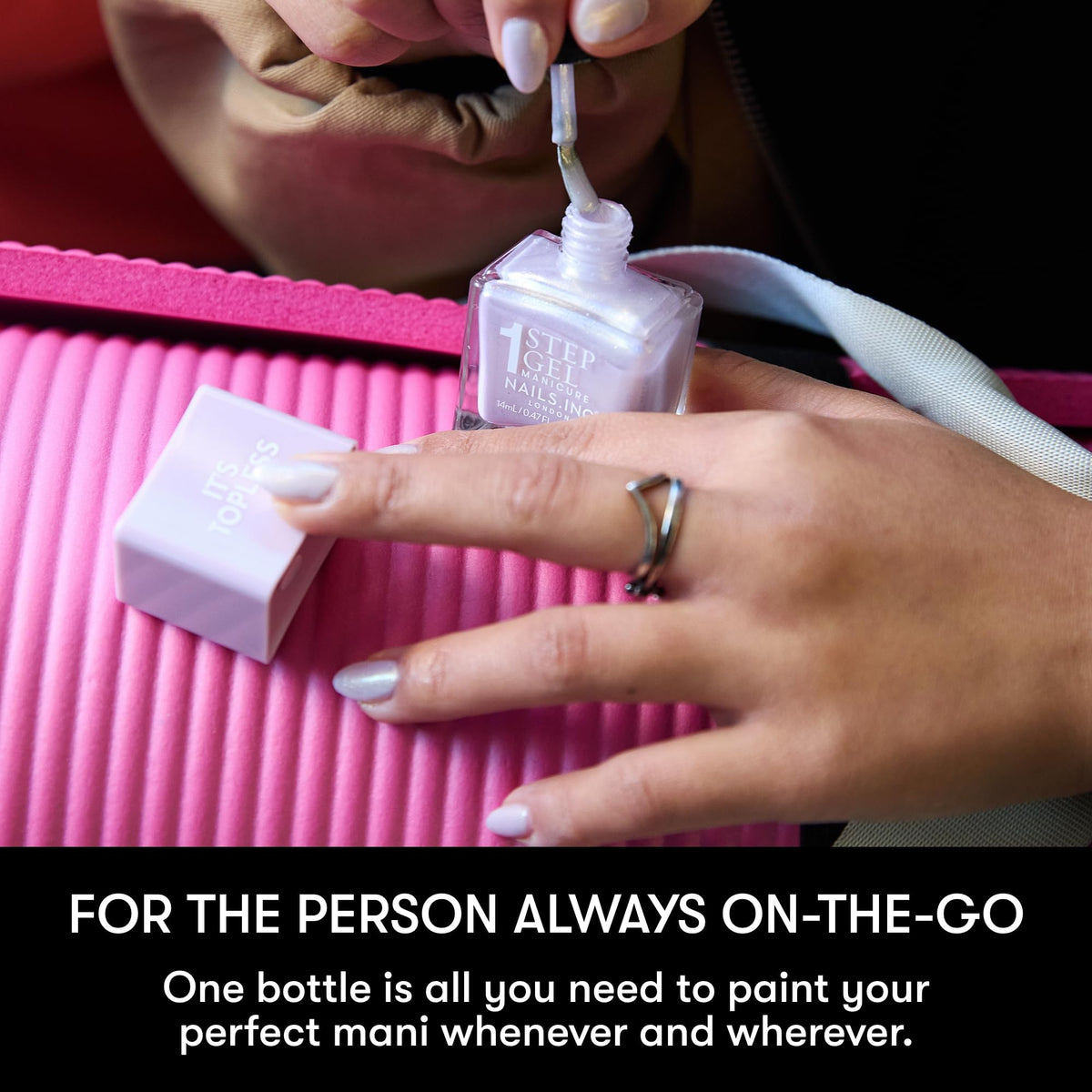 Nails Inc bottle held in hand to show size and travel-friendly scale