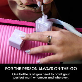 Nails Inc bottle held in hand to show size and travel-friendly scale