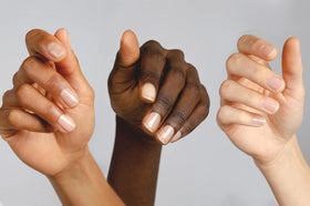 Applying Nailtiques to a fingernail to illustrate easy home treatment benefit