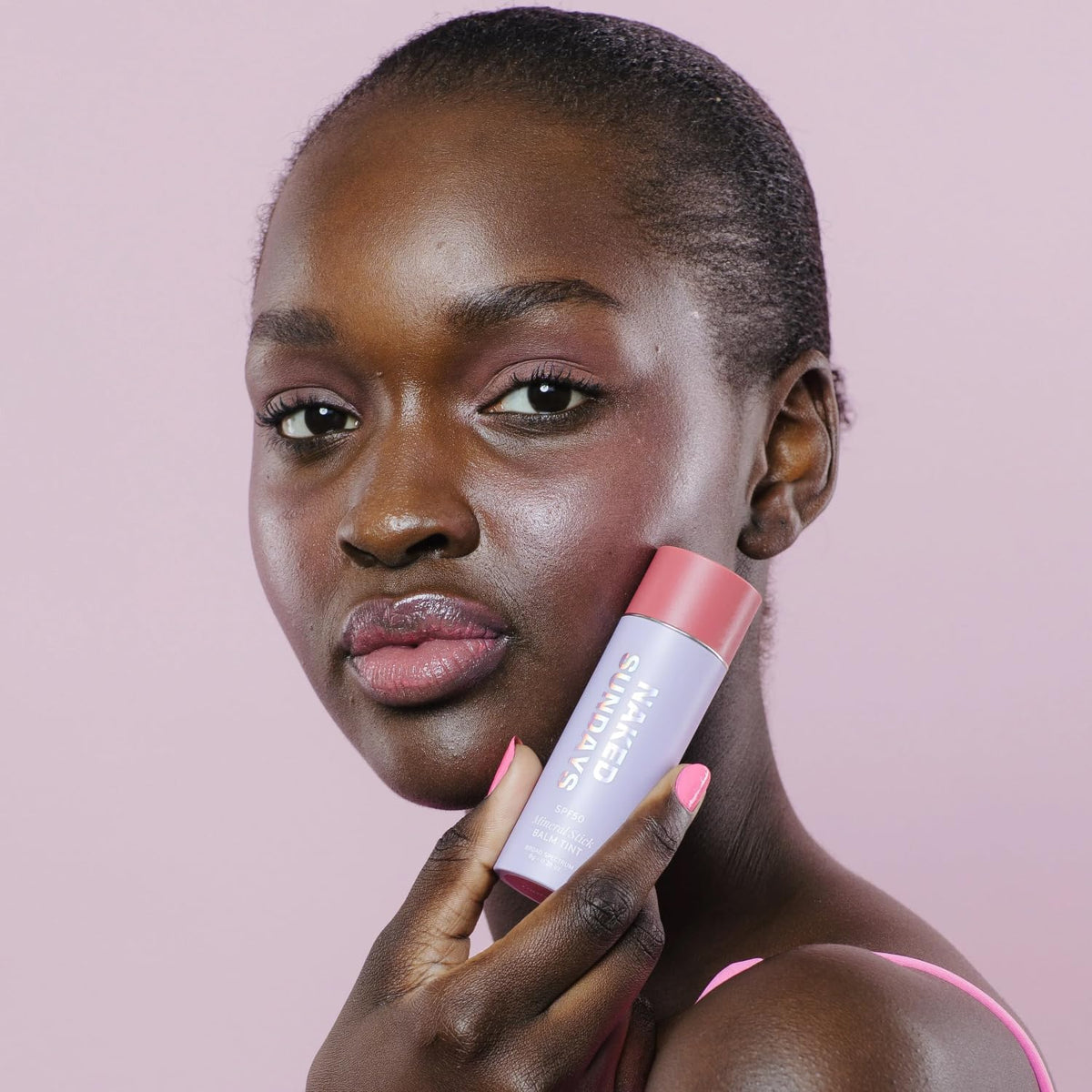 Naked Sundays dabbed on lips for tinted balm and sun protection