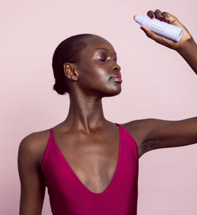 Naked Sundays mist visible in air highlighting lightweight texture and quick-dry benefit