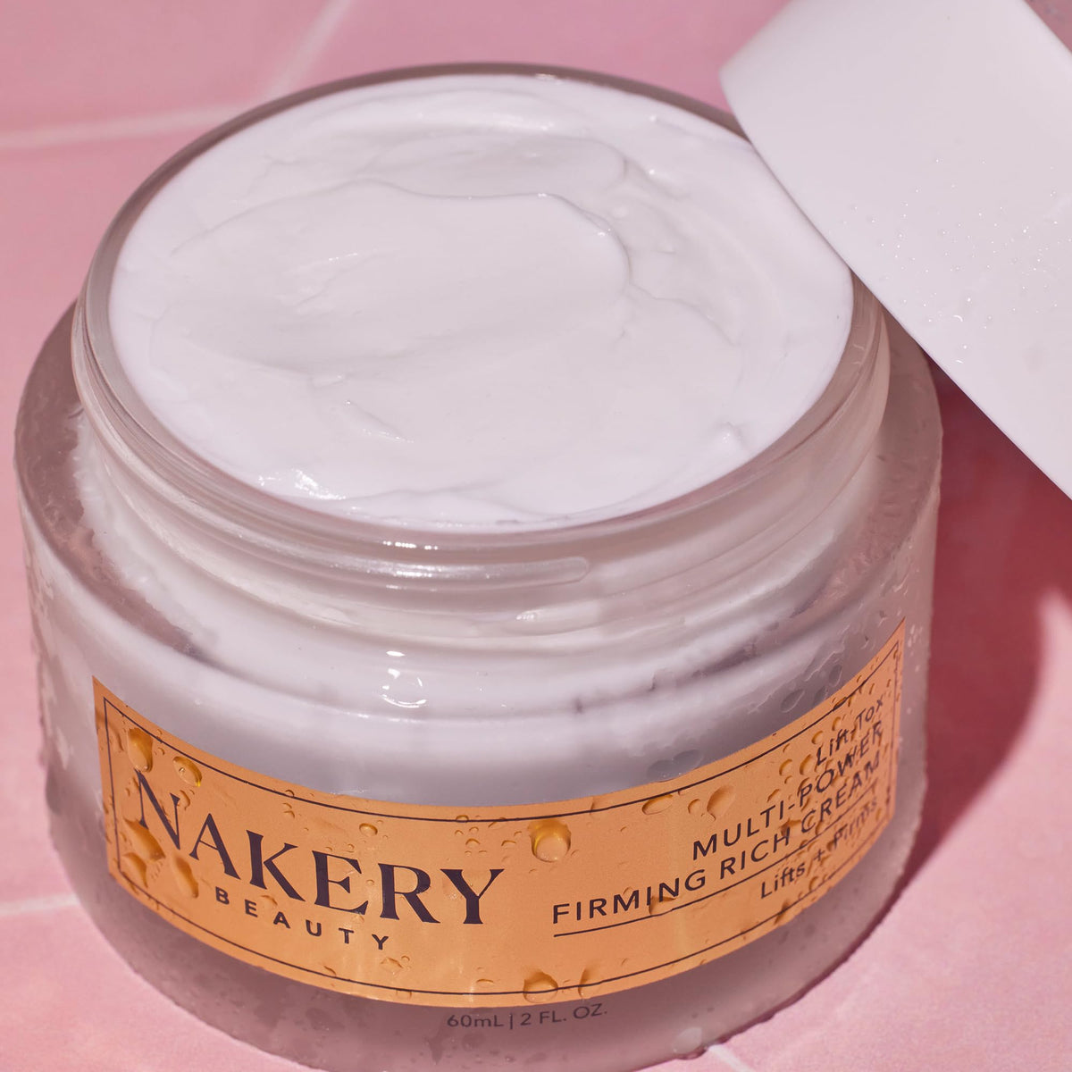 Nakery Lift-Tox jar held in hand showing scale and travel-friendly size