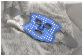 Nanoleaf mask size comparison next to hand to illustrate compact, wearable scale