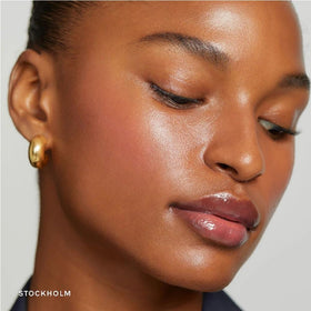 NAPH flush balm dabbed on lips showing hydrating tint and soft color