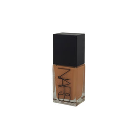 NARS size comparison with a 30ml bottle next to a coin showing travel-friendly volume benefit