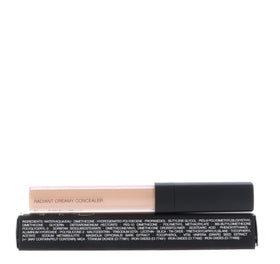 Applying NARS concealer under eye with fingertip to brighten and conceal dark circles