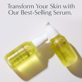 NassifMD applying serum to face in mirror showing smooth layering under makeup