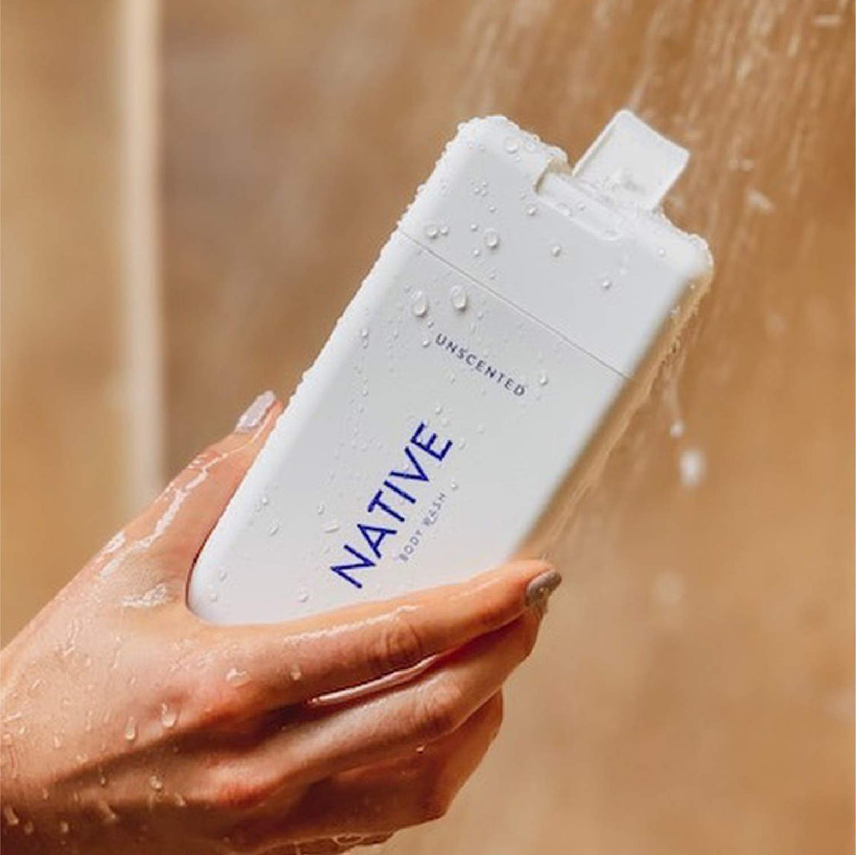 Native bottles next to hand for scale showing travel and convenience benefit