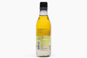 Natura triple phase bottle before shaking, highlights layered oil visual and ritual