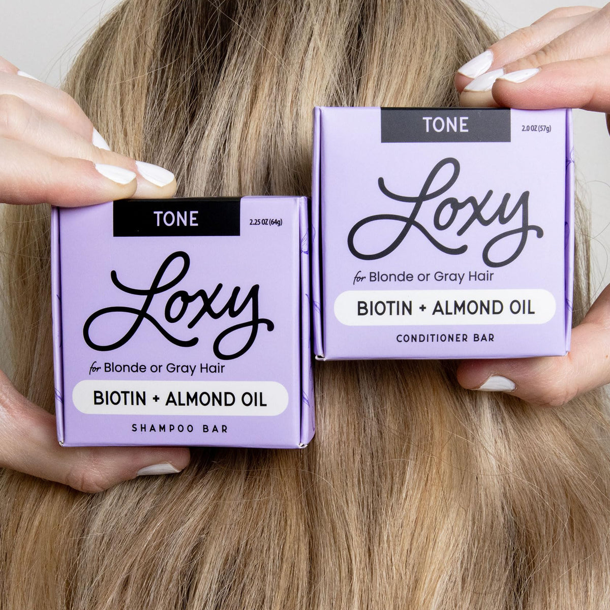 NATURÉL conditioner bar applied to hair ends to show smoothing and added shine