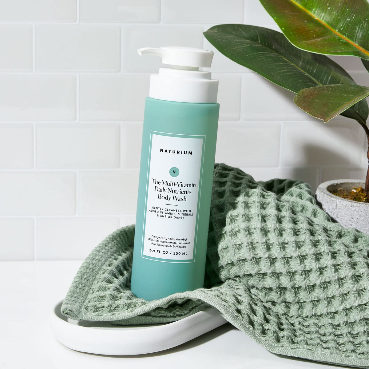 Naturium body wash in bathroom setting promoting everyday routine benefit