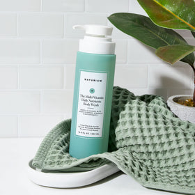 Naturium body wash in bathroom setting promoting everyday routine benefit