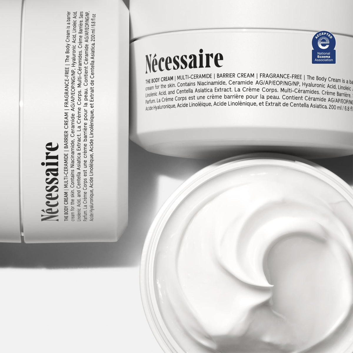 Nécessaire cream texture spread on skin showing rich emollient feel and moisturization