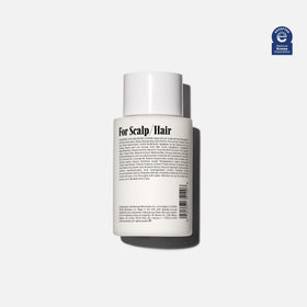 Nécessaire mini conditioner cap detail illustrating easy dispensing and leak prevention