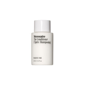 Nécessaire mini conditioner front bottle showing compact travel size and clarity